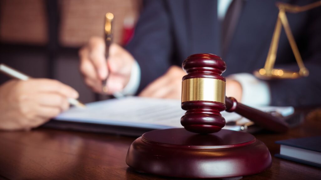 Attorney taking notes for a video deposition